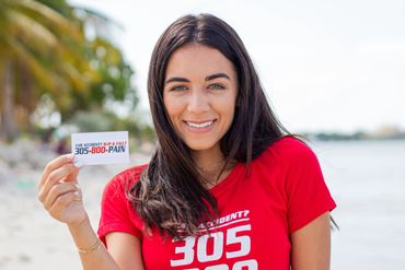 A woman holding 305800 Pain's business card