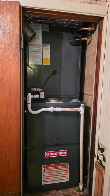 Goodman HVAC unit installed in a closet space.