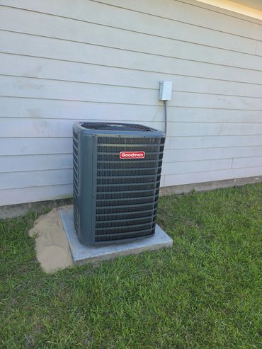Goodman air conditioning unit outside a house.