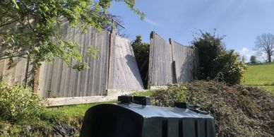 Broken wooden fence panels - later fixed by hurricane fencing.
