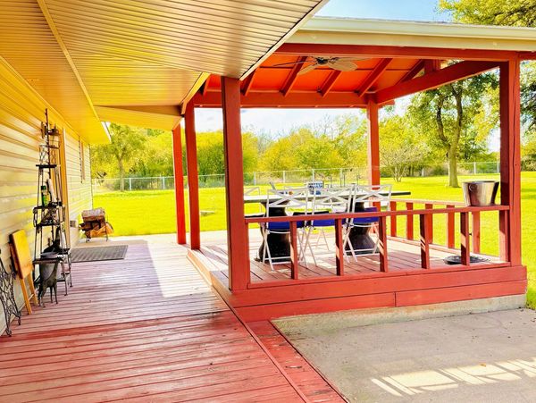 Back covered porch with concrete patio surrounds for grilling and more space