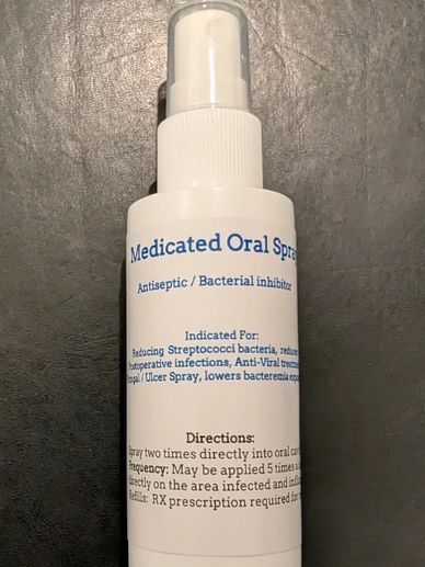 Bottle of medicated oral spray with instructions.