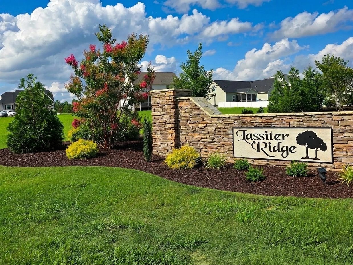Stone entrance sign for Lassiter Ridge neighborhood with landscaping.