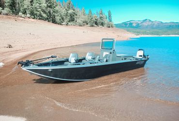 Boulton aluminum powerboat on the shore of a lake