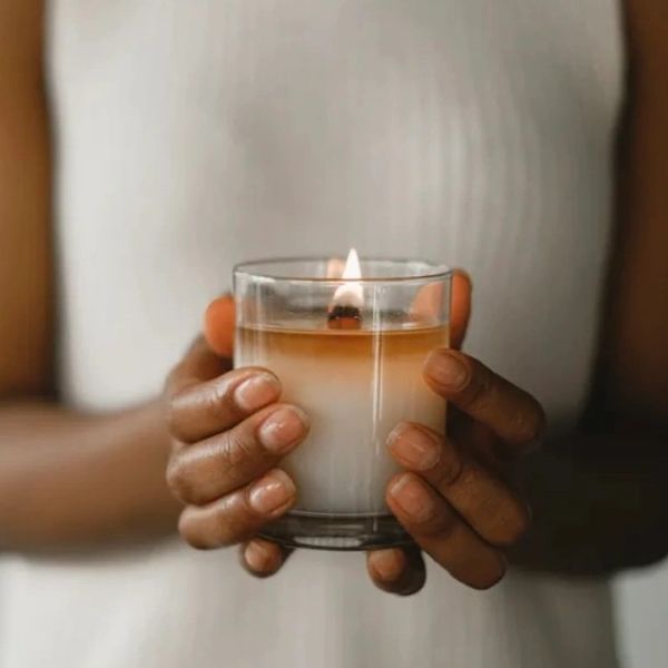 Holding a candle and grieving the loss of a loved one