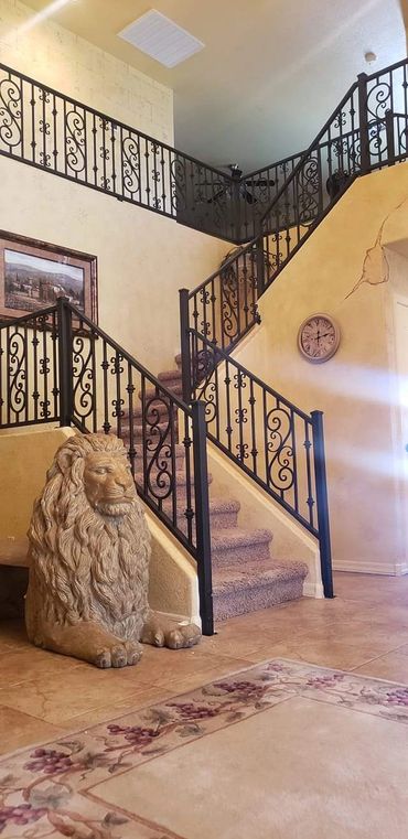 Decorative steel stair and balcony railings with scrollwork in a Peoria, Arizona home.