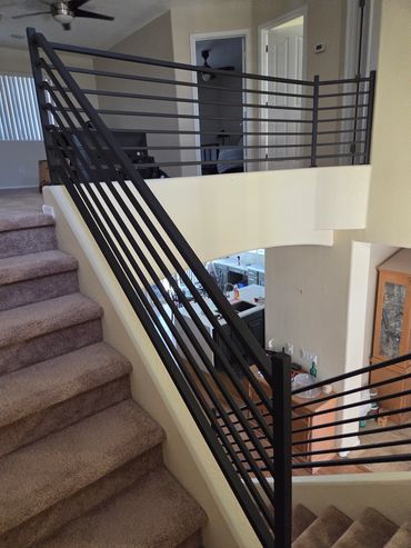 Modern horizontal interior stair and balcony railing.
