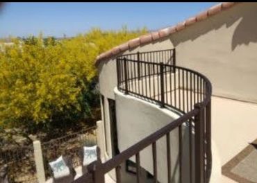 Custom curved exterior iron deck railing.