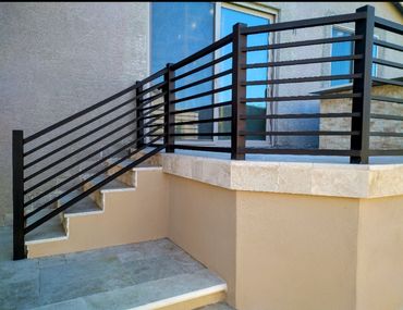 Modern exterior steel stair railings with horizontal pickets.