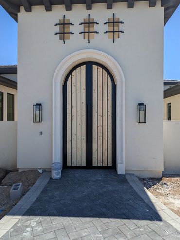 Front entry portico gate with decorative arch top design.