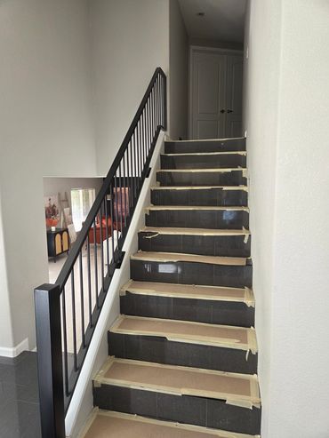 Steel stair railing with square balusters for a modern home.