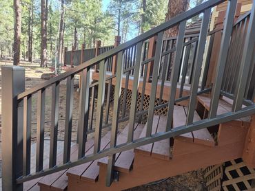 Steel deck stair railings with vertical pickets for a mountain home.