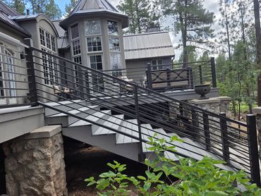 Steel stair and deck railings with horizontal pickets for a Flagstaff mountain home.