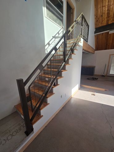 Wrought iron stair railing in Waddell, Arizona, featuring a custom design and bronze hammered finish
