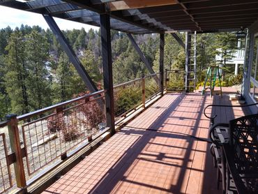 Industrial-style steel deck railing with raw metal finish and welded wire mesh panels, Flagstaff AZ