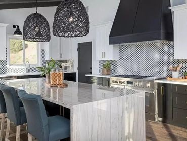 White kitchen remodel with wood island accents, pendant lighting, and custom cabinetry