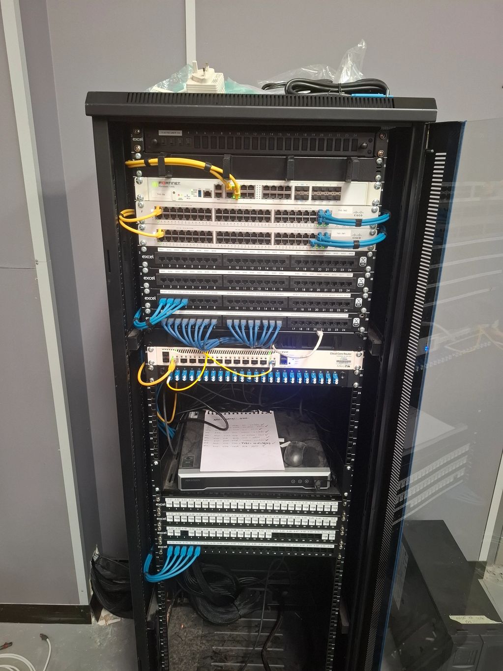 A server rack filled with network switches and patch panels.