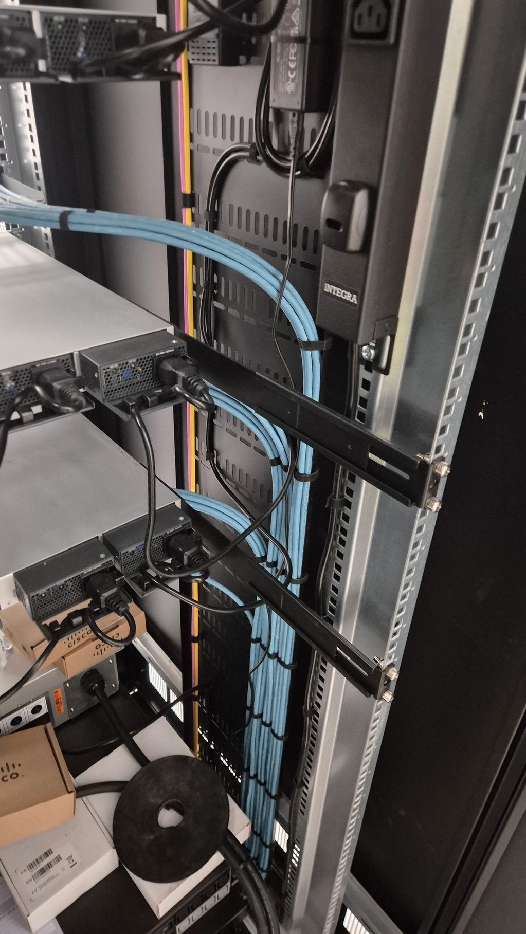 Organized network cables and equipment in a server rack.