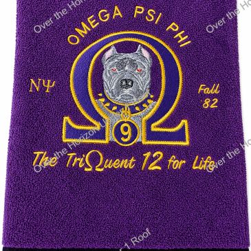 Embroidered purple cloth with Omega Psi Phi fraternity symbols and dog.