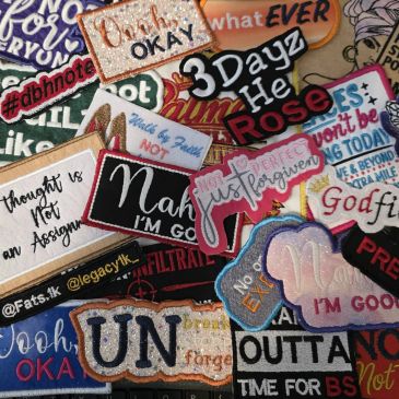Collection of assorted fabric patches with various words and phrases.