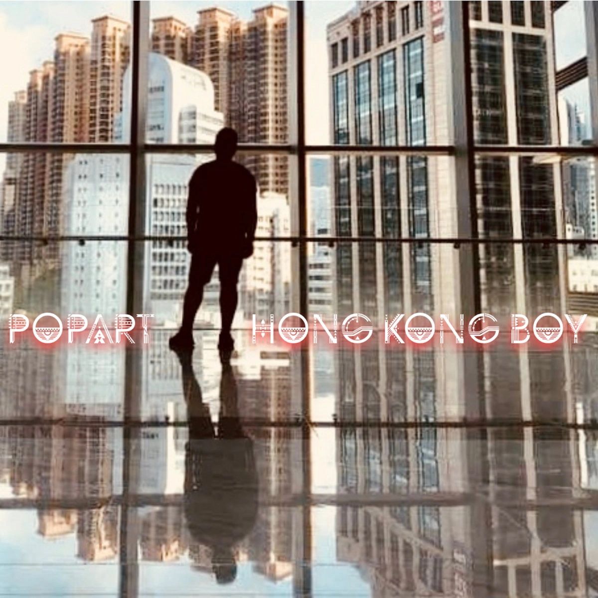 Silhouette of a man looking at Hong Kong skyscrapers through a large window.