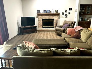 Cozy living room with a fireplace and TV setup.