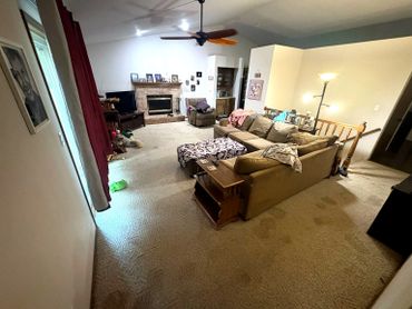 Cozy living room with a sectional sofa, armchair, and a fireplace.