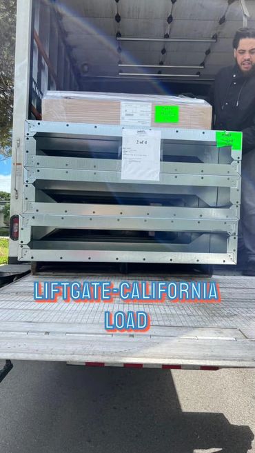 Metal frames and boxes loaded on a truck liftgate in California.
