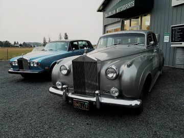 Classic cars in front of the Maximilian Motorsports awning.