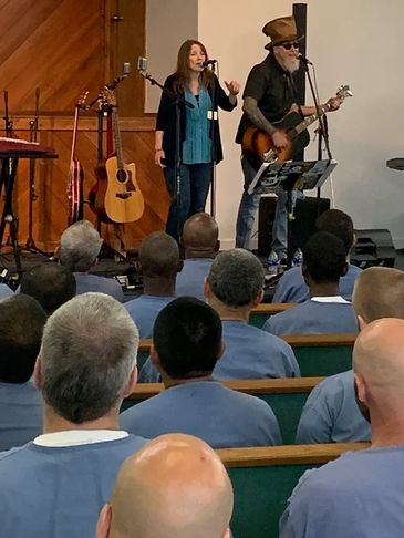Musicians perform for an audience in a room.