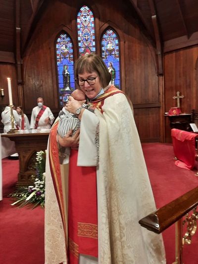 Image of Dean Julia holding a baby