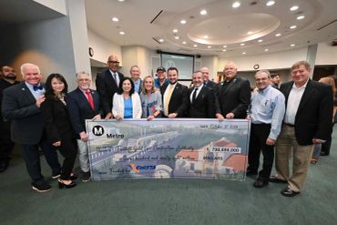 Group of people holding a large $798 million check for the Gold Line project..