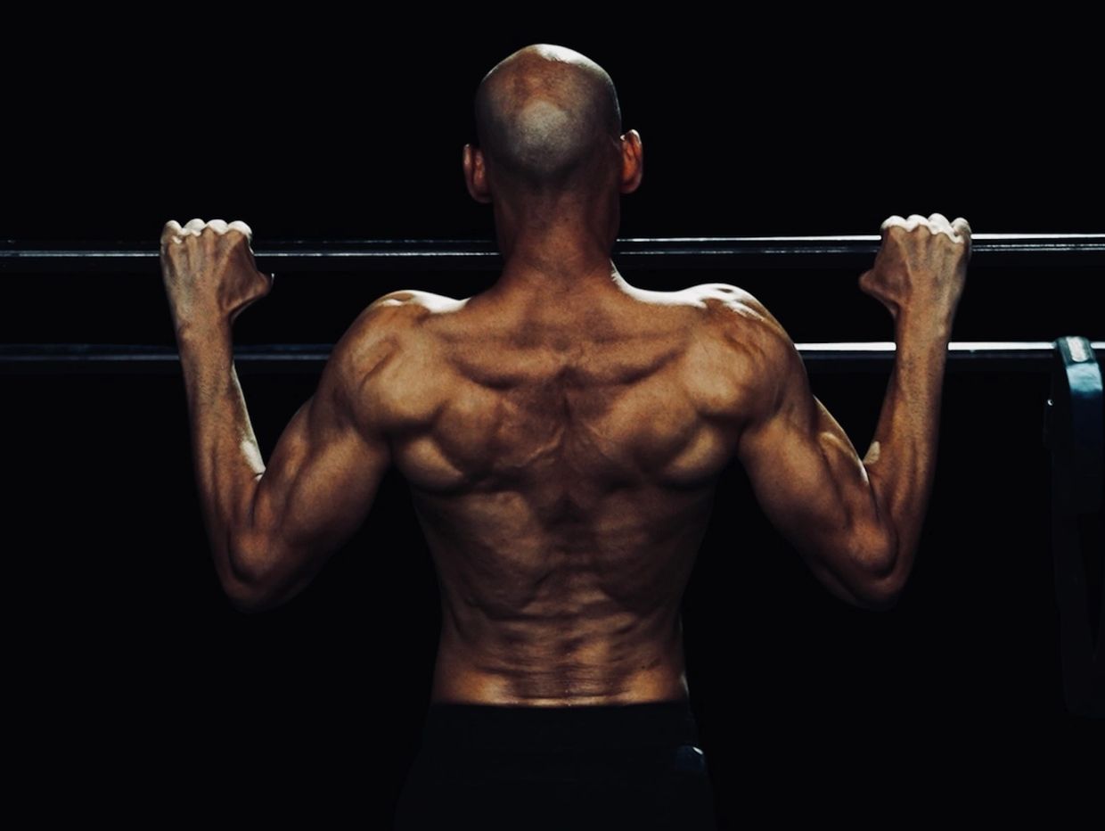 Manish Yadav is doing Pull-up exercise.