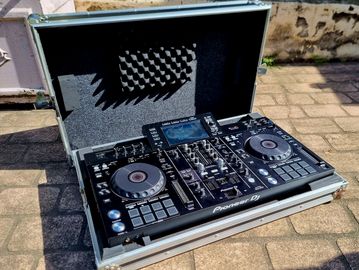 Pioneer DJ controller in a case outdoors.