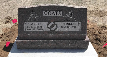 Headstone with two names and dates in a cemetery.