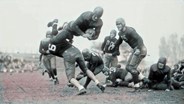 Bronko Nagurski, Minnesota Golden Gopher, leaping through the air in a 26-14 defeat of Northwestern,