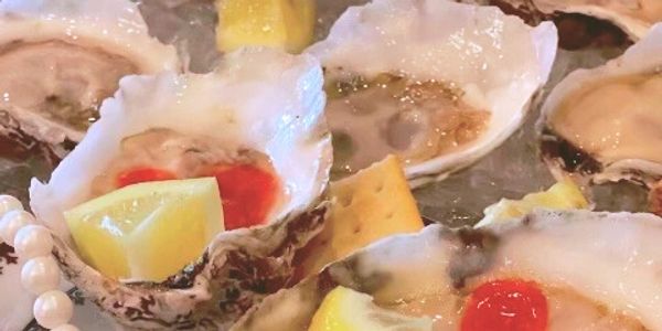 Nomini Bay Oysters on ice with garnishes