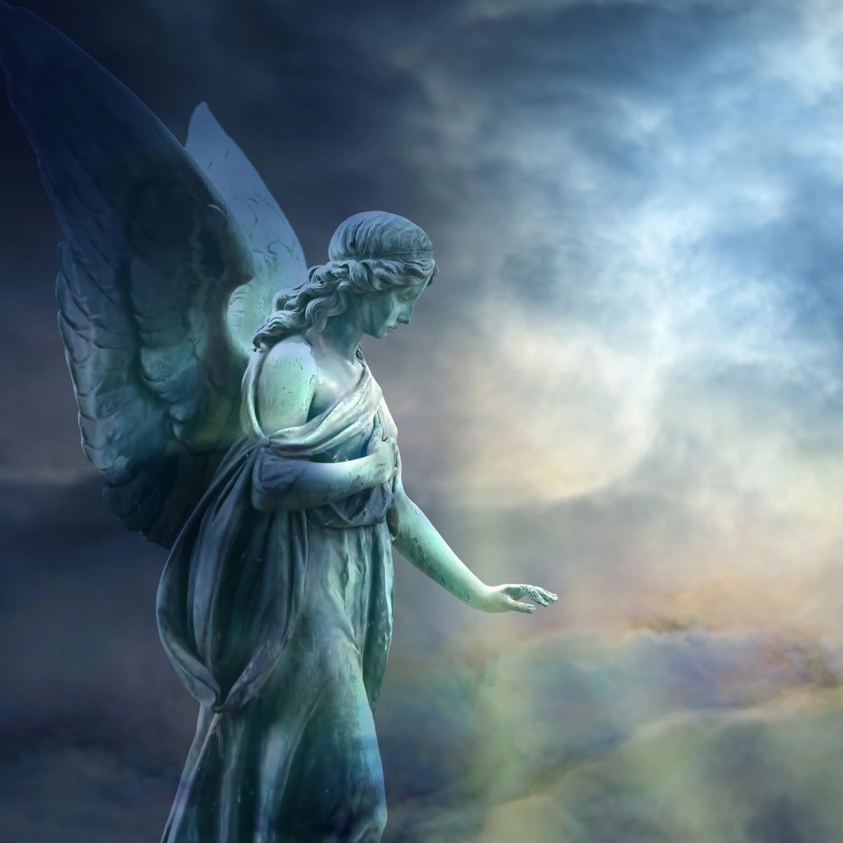 Angel statue in front of clouds.