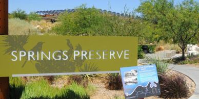 Sign for Springs Preserve in a natural setting.