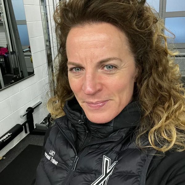 Personal trainer Lucy in a gym wearing a black vest.