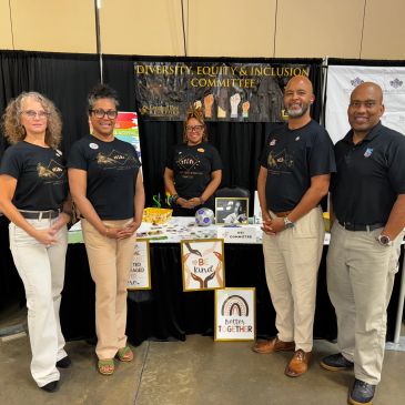 Diversity, Equity & Inclusion Committee members at booth.