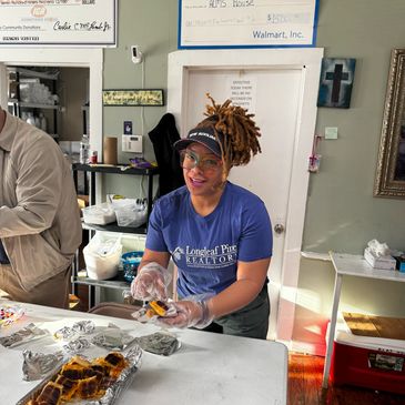 Volunteer serving food at a community kitchen.
