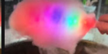 Colorful cotton candy lit up with rainbow lights.