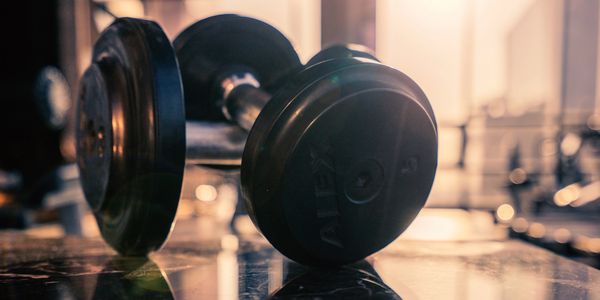 closeup shot of two dumbbells on the floor 