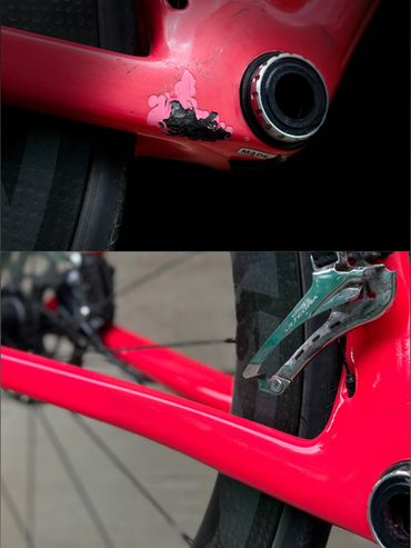 Close-up of a red bicycle frame showing paint damage and Shimano Ultegra components.