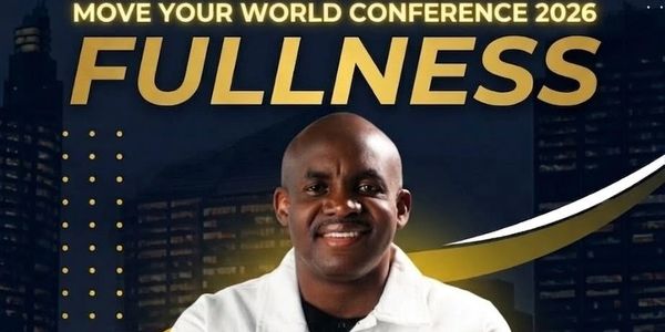 Man smiling in front of a conference banner titled FULLNESS 2026.