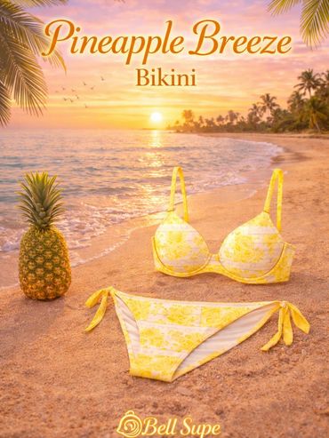 Yellow floral bikini on a beach at sunset with a pineapple beside it.