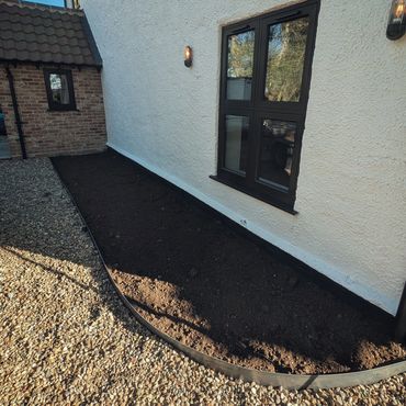 Raw steel edging installed to flower bed
