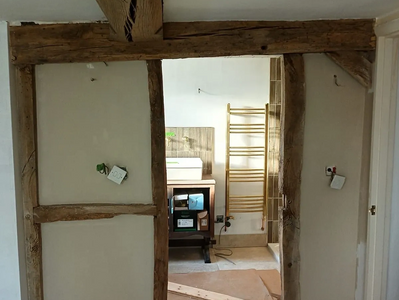 Interior alterations to create an ensuite bathroom, using reclaimed beams.