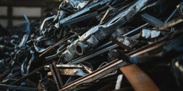 Pile of rusted and crushed metal scrap at a junkyard.